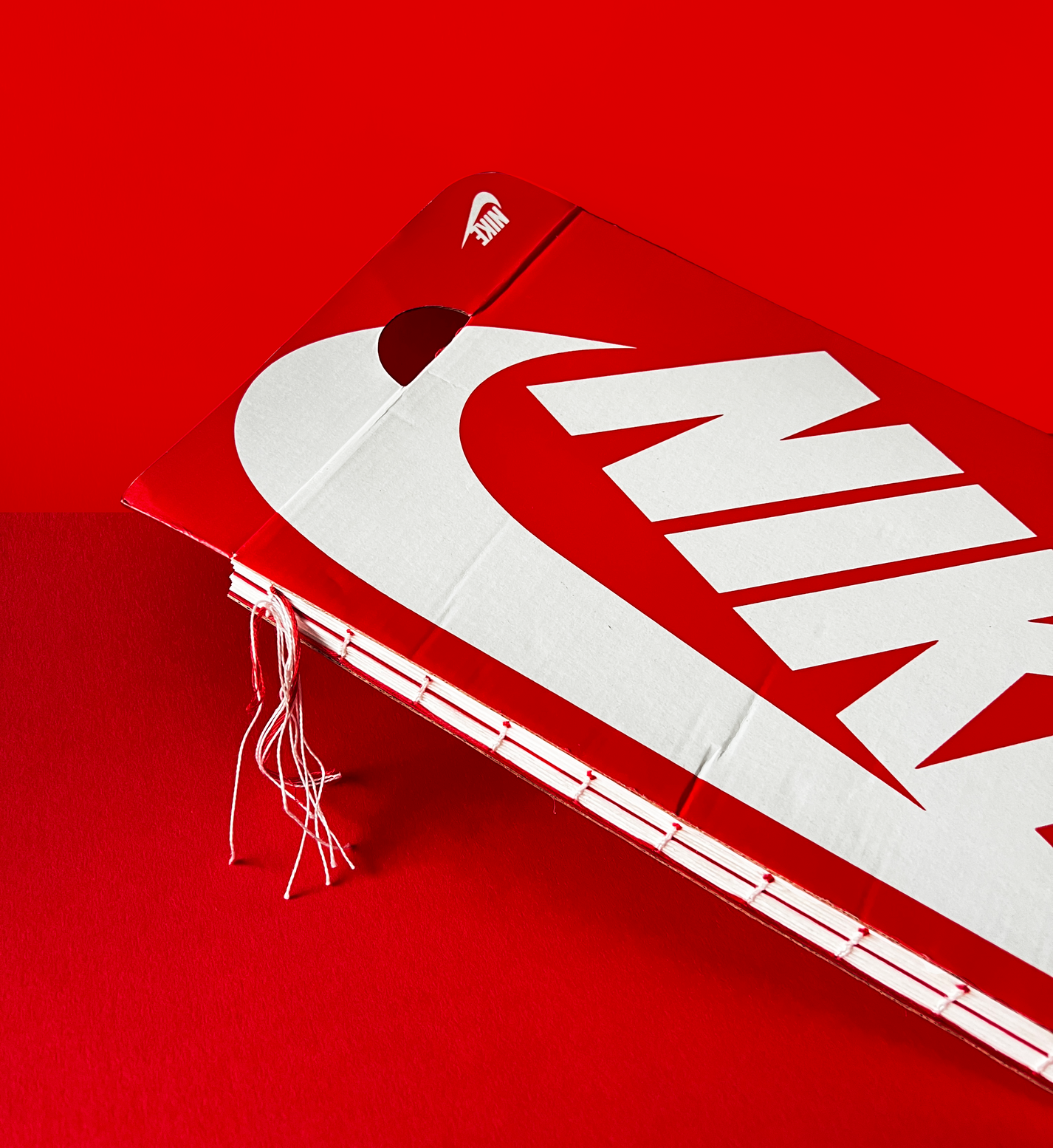 I turned a Nike Shoebox into a journal. The exposed strings emulate Nike laces and clothing, and the shape almost emulates that of a fuel carton. 